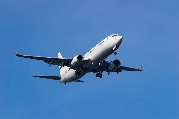 Boeing 737 flying against blue sky